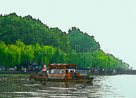 china-people-on-raft-blue-sky-green-trees
